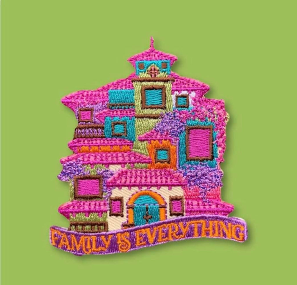 “Embroidered patch featuring a colorful stacked house with multiple windows and doors in pink, purple, teal, and orange tones, with decorative stitched text along the bottom.”