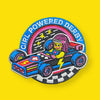 Embroidered patch of a girl in a derby car with 'Girl Powered Derby' text on a yellow background