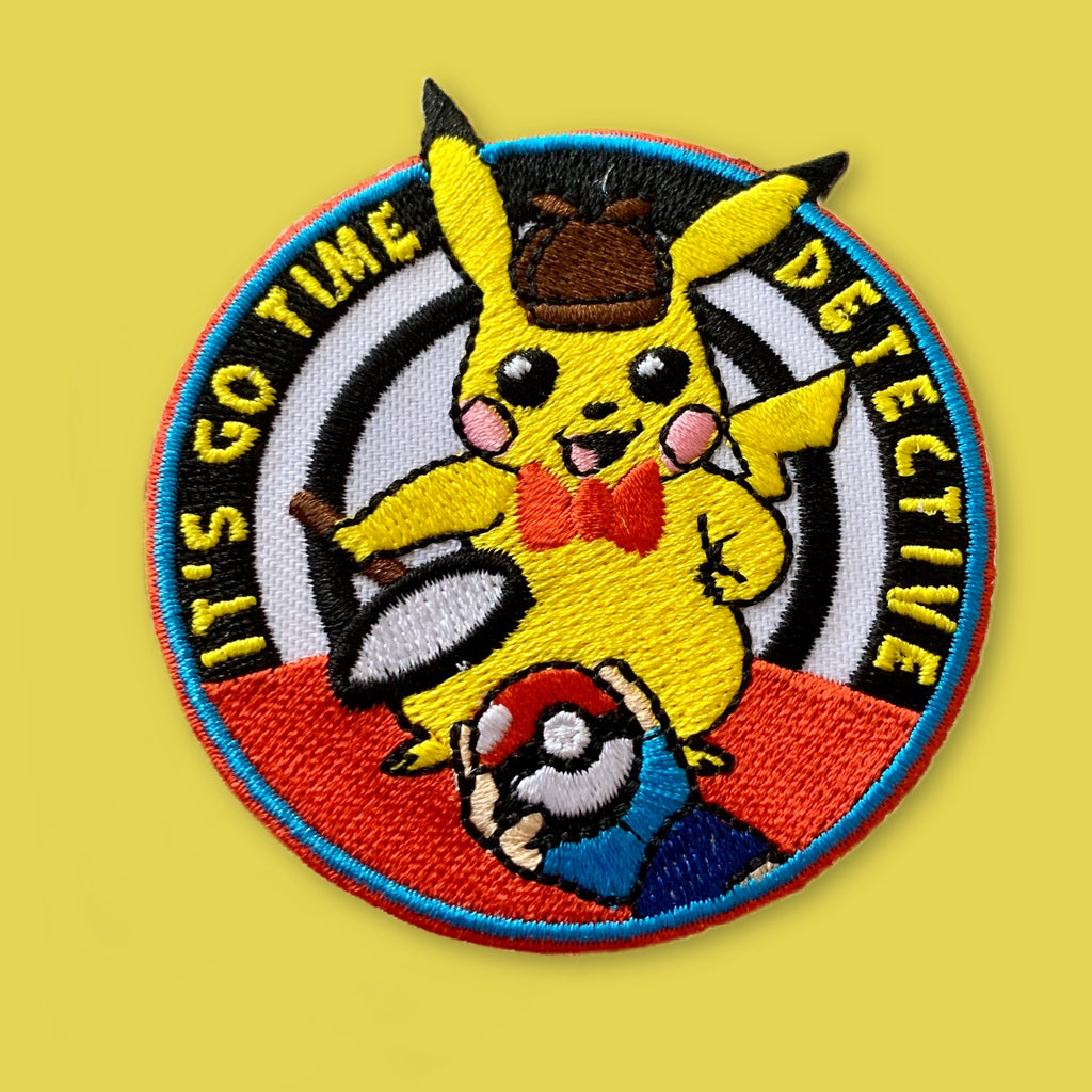 Embroidered detective-themed patch with a cartoon character, magnifying glass, and ‘It’s Go Time Detective’ text.