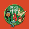 “Embroidered circular patch with a green background featuring a red-haired mermaid seated at center, surrounded by stylized character silhouettes, a golden fairy figure, and white decorative lettering, stitched in green, red, gold, and teal.”