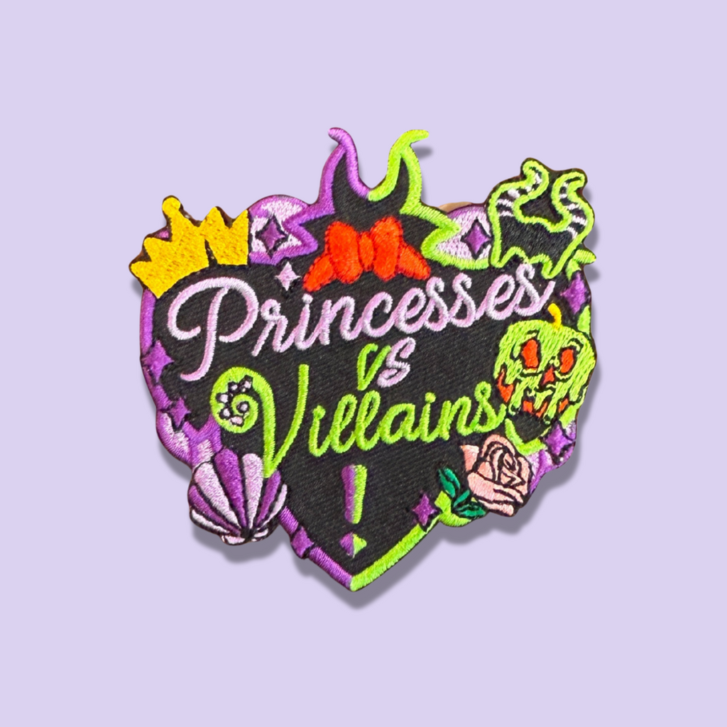 Embroidered ‘Royals vs Villains’ patch with spooky fairytale-style icons in purple, green, and black.