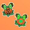 Embroidered Halloween pumpkin patch with a green bow and leafy details.